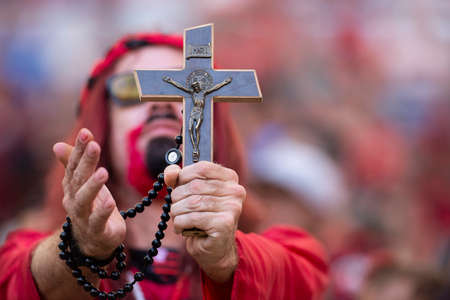 Rio, Brazil - april 21, 2019: fans holds a cross and prays in match between Flamengo and Vasco by the final Carioca Championship in Maracana Stadiumのeditorial素材