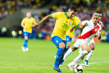 Rio, Brazil - July 7, 2019: Roberto Firmino of Brazil kicks the ball during the 2019 America Cup finals game between Brazil and Peru at Maracana Stadium.のeditorial素材