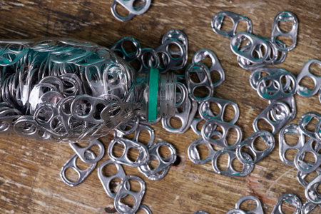 aluminum pull tabs inside plastic bottle to recicle