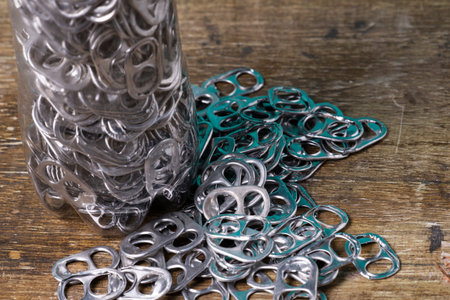 aluminum pull tabs inside plastic bottle to recicle