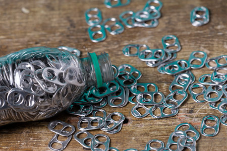 aluminum pull tabs inside plastic bottle to recicle
