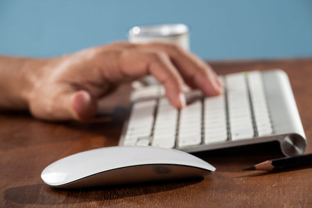 Business man using computer. Man typing on a work desk keyboard