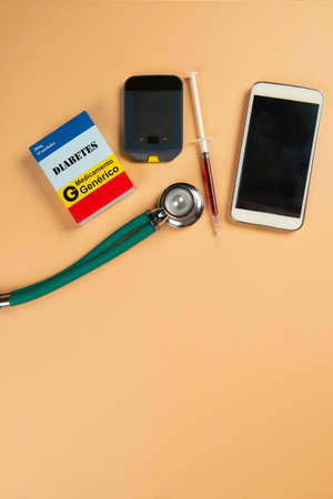 Fake medicine box with the name of the disease Diabetes and a glucometerの写真素材