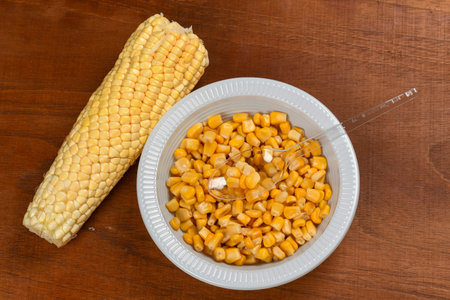 plastic plate with corn cooked in Brazilian June party