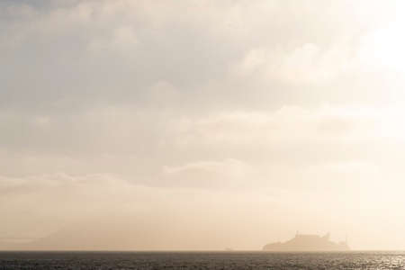 USA, San Francisco - june circa, 2019: view of alcatraz island from afar in silhouette and mist, tourism place on had penitentiaryのeditorial素材