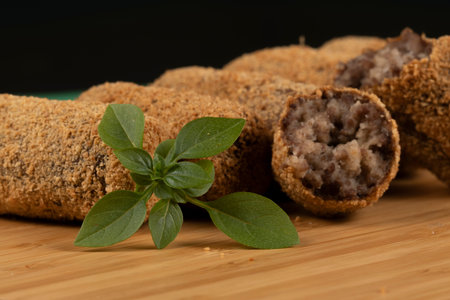 fried meat croquette dumpling on a black backgroundの写真素材