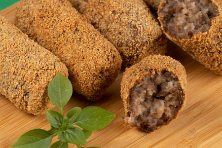 fried meat croquette dumpling on a bamboo boardの写真素材