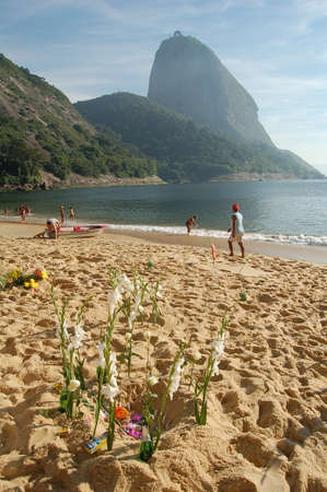 Rio de Janeiro, Brazil - december 31, 2005: Yemanja's offerings. Population throws flowers to the sea to thank and make requests to the patron saint on the beach.のeditorial素材