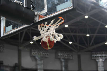 Basketball ball entering the ring and falling through the net with copy spaceのeditorial素材