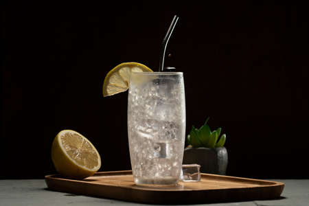 Tom Collins cocktail in a black background, eco-friendly metal strawの写真素材