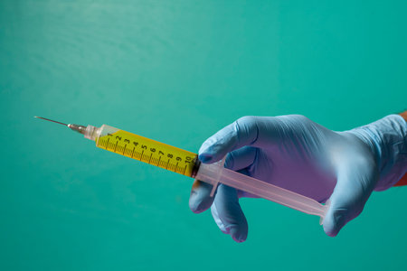 healthcare professional holding a syringe ready to give the injection.