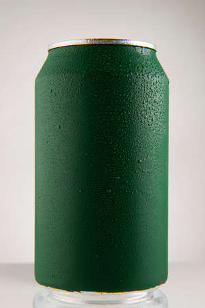 Green chilled can of soda with drops on white background and drop, in front viewの写真素材