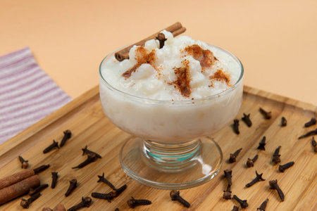 bowl of hominy (Canjica) on a wooden tray, typical Brazilian food at the June festivalsの写真素材