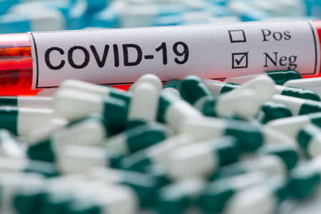 blood collection tube for clinical analysis, with covid-19 label, and capsules of medicine pillsの写真素材