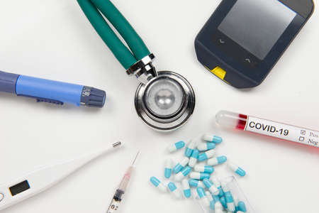 Top view of flat lay of medical supplies for the treatment of the patient - arranged in a circle around the stethoscope in a white back groundの写真素材