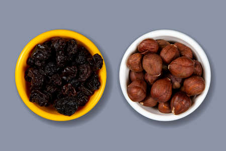 bowls with culinary ingredients Pass grape hazelnut on colour background. Top Viewの写真素材