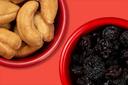 jars with fresh food with cashews and another with raisins. Top viewの写真素材