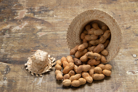 peanuts with shell coming out of a typical June party (festa junina) hat, Up view with copy text.の写真素材