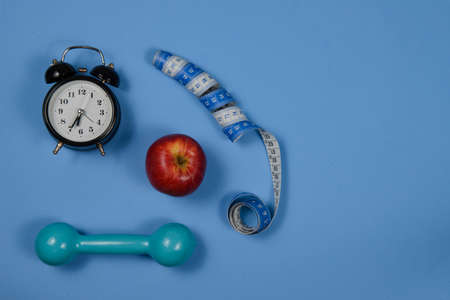 alarm clock, apple fruit and exercise weight with space for writing text. Top Viewの写真素材