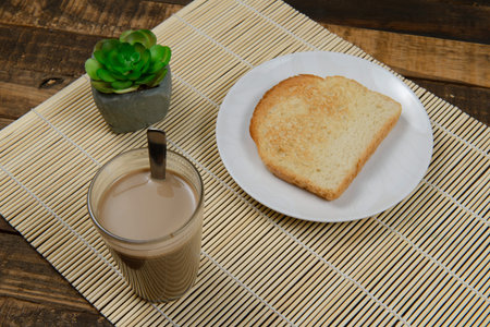 typical brazilian small breakfast, with cup of coffee with milk and bread