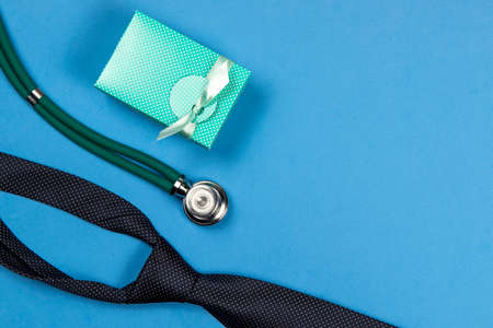gift box tie and stethoscope symbolizing fathers days for a doctorの写真素材