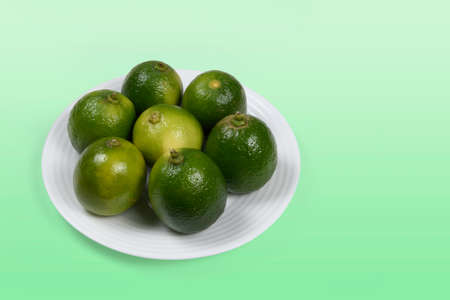 White dish with whole Tahiti lemon, typical in Brazilの写真素材