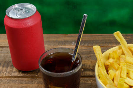 portion of potato fries in a bowl with sodaの写真素材