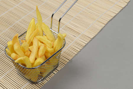 portion of potato chips in a metal basketの写真素材