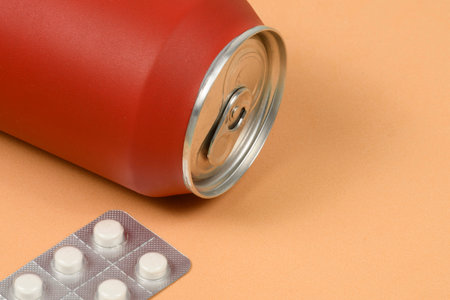 red soda cans with weight loss medicine on the sideの写真素材