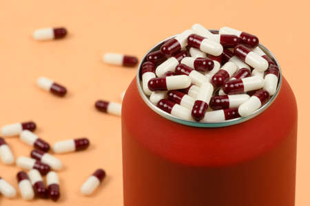 red soda cans with weight loss medicine on the sideの写真素材