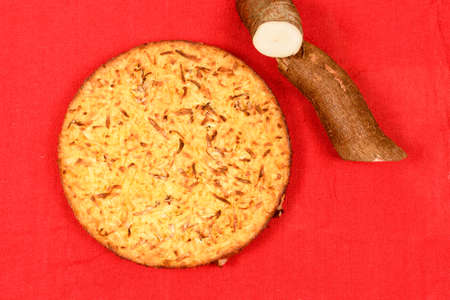 Whole cassava cake on red fabric background.の写真素材