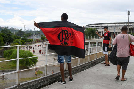 Rio, Brazil - February 21, 2021: Flamengo fans attend outside the MaracanÃ£ stadium, which cannot receive an audience due to a pandemic, to support the team in the match against the Internacional team, this Sunday afternoon (21)のeditorial素材