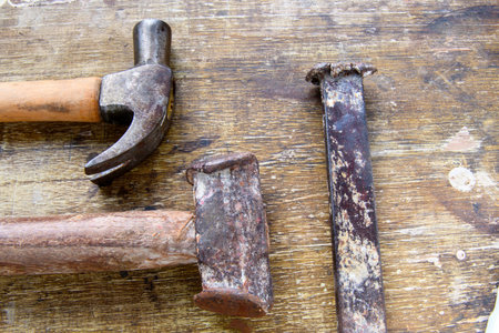 Two hammers lined up on aged wood as a background.の写真素材