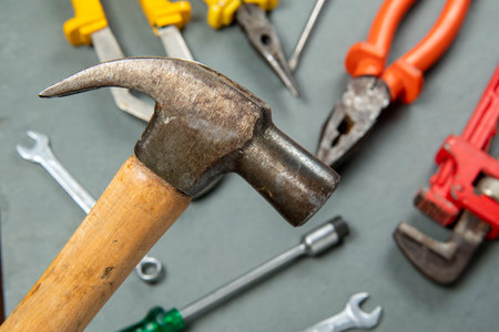 hammer isolated on blurred background with a variety of toolsの写真素材