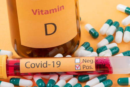 Vitamin D container with capsules around it and a vacuum tube with the text Covid-19