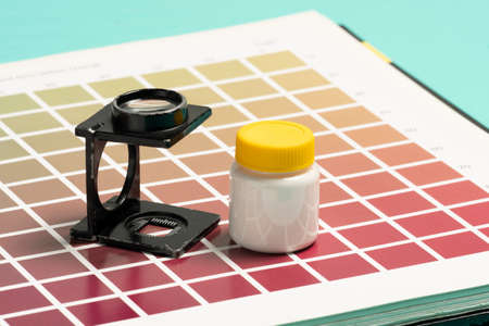Wire-type magnifying glass on samples of color scale for printing and lithographyの写真素材