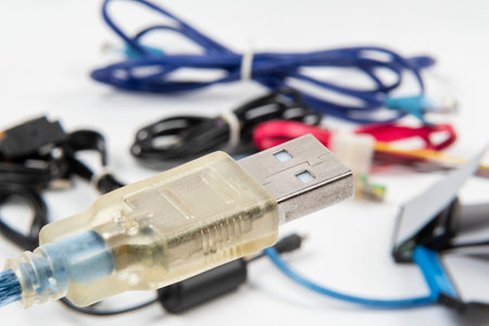 technological waste that remains in residence as computer cables. Plug on focus, defocus background