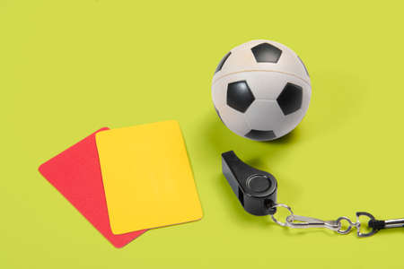 Soccer ball, yellow and red cards and referee whistleの写真素材