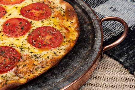 Neapolitan Brazilian pizza with mozzarella cheese and tomato slices with oregano, top viewの写真素材