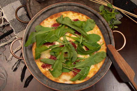 Brazilian pizza with sun-dried tomatoes, arugula and mozzarella. Traditional Brazilian Pizzaの写真素材