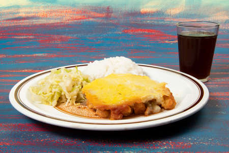 Typical Brazilian food dish: mashed potato pie with chicken and sautÃ©ed cabbage leaves and riceの写真素材