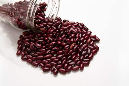 glass jar with fallen beans seed and pile outside