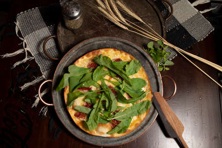 Brazilian pizza with sun-dried tomatoes, arugula and mozzarella. Traditional Brazilian Pizzaの写真素材