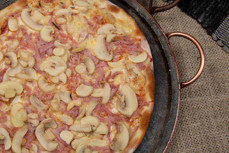Brazilian mushroom, cheese and ham pizza, top viewの写真素材