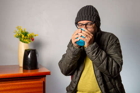 person serving coffee with warm clothesの写真素材