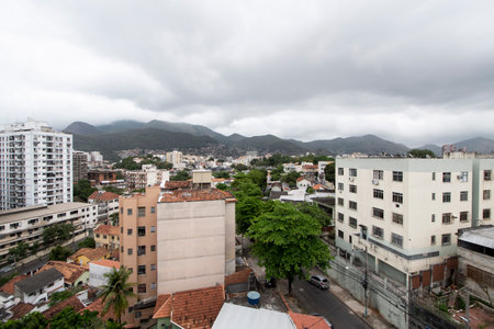 Rio, Brazil - September 16, 2021: aerial view of densely populated urban area with houses and buildings and mountain in the background on cloudy day.のeditorial素材