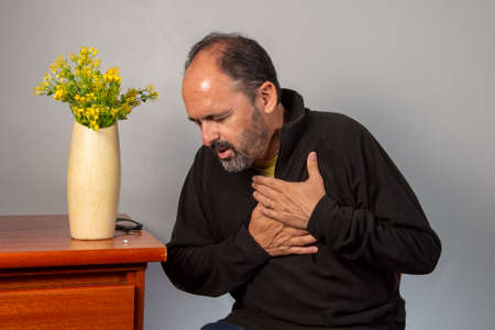 Senior man with shoulder pain. Middle-aged gentleman is in horrible pain. Neck and shoulder pain suffering from neck and shoulder injury, person with health problemの写真素材