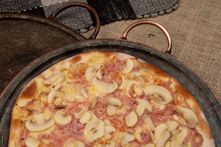 Brazilian mushroom, cheese and ham pizza, top viewの写真素材