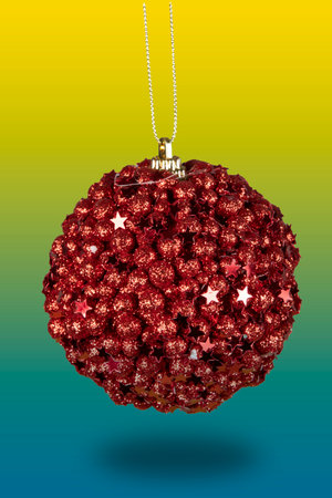red christmas ball cut out on colorful backgroundの写真素材