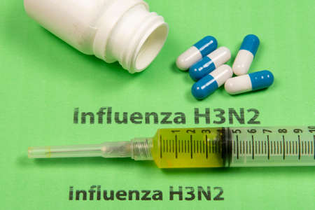 medicines, syringe, in a conceptual situation for the H3N2 flu that spreads across several countriesの写真素材